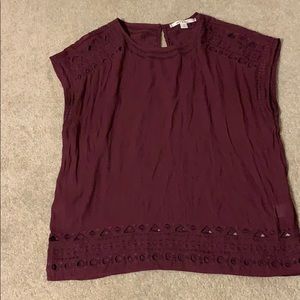 Maroon shirt with designs.
